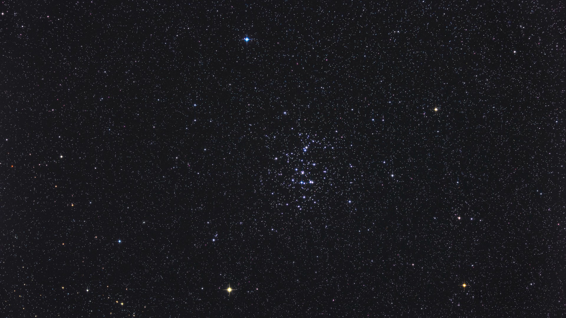 a dense, colorful group of stars in the night sky
