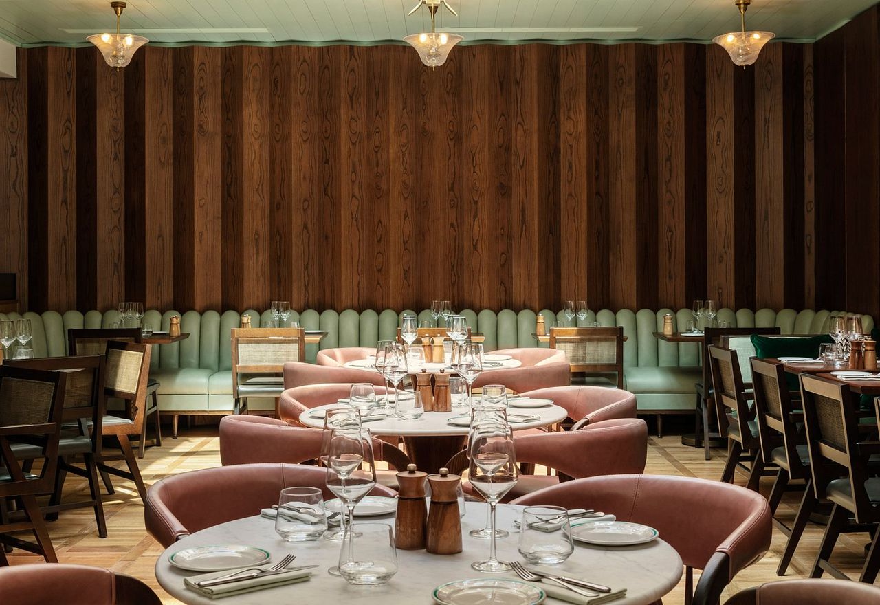 An imaginatively decorated Roman hotel features a green and brown colo scheme, whimsical furniture, and lots of leather accents.
