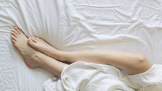 Woman's legs on bed