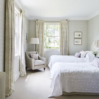 guest bedroom with twin beds and armchair