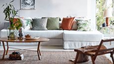 H&M Home: Living room with tropical print cushions and a white sofa 