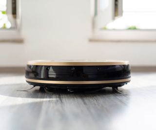 A robot vacuum on faux wood floor