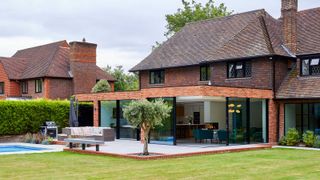 Modern single storey extension to traditional house with modern patio and swimming pool