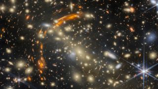 Galaxy cluster gravitationally lensing another, more distant galaxy cluster.