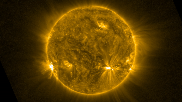 A short video clip showing the surface of the sun with bright yellow and white regions. A piece of magnetized plasma appears to slither across the surface from the lower right to the upper left portion of the sun.