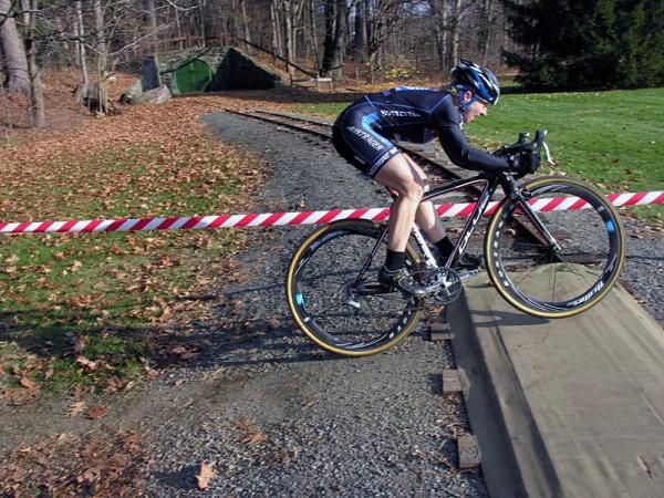 Laura Van Gilder jumps over the train tracks.