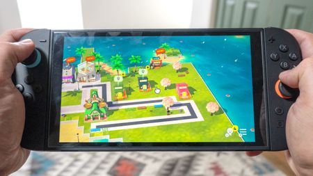 A person playing Tomodachi Life: Living the Dream on the Nintendo Switch 2 in handheld mode