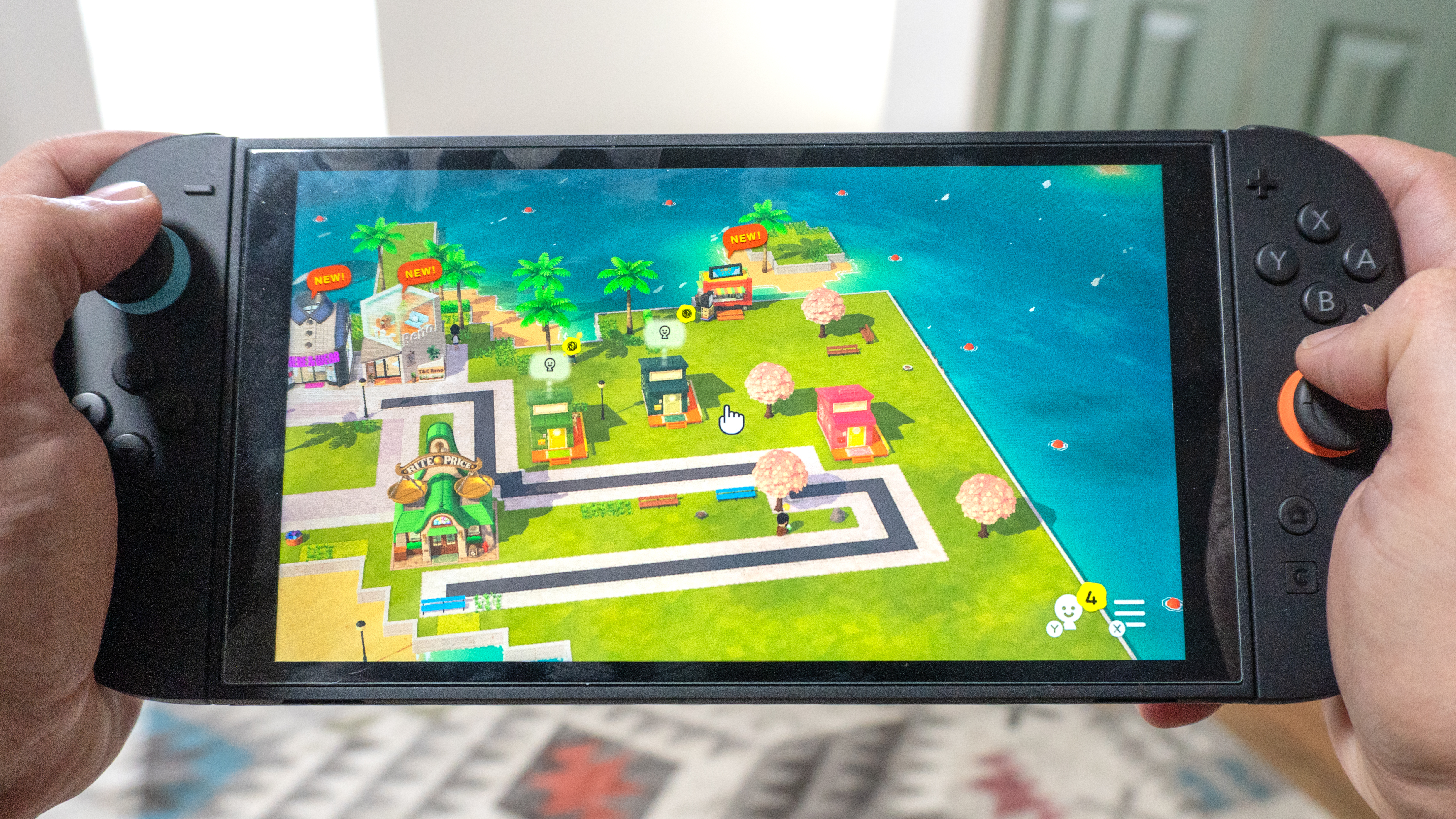 A person playing Tomodachi Life: Living the Dream on the Nintendo Switch 2 in handheld mode