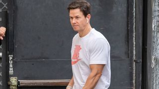 Mark Wahlberg walking with airpods
