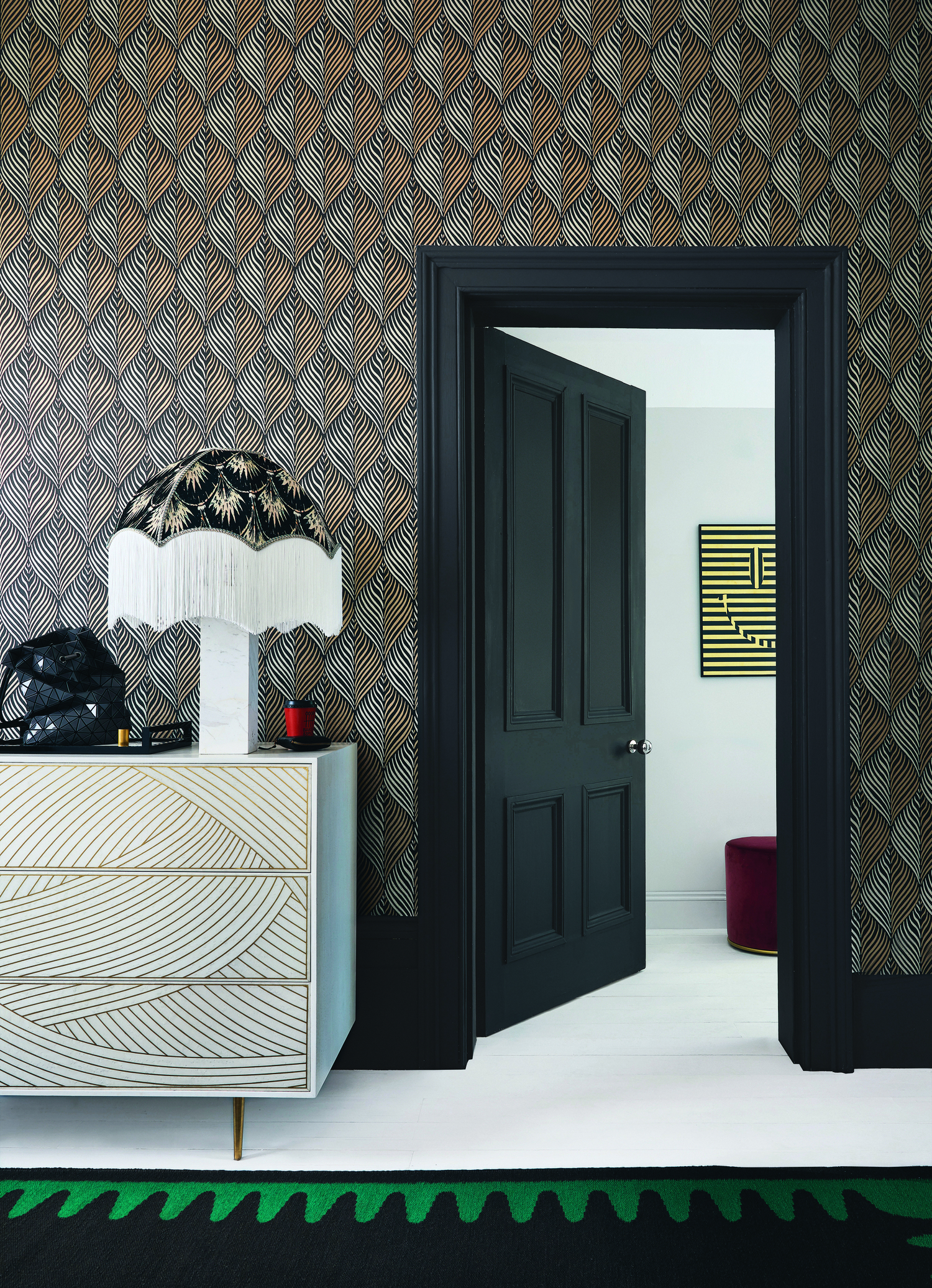 A black and white themed room with a door and door trim painted black