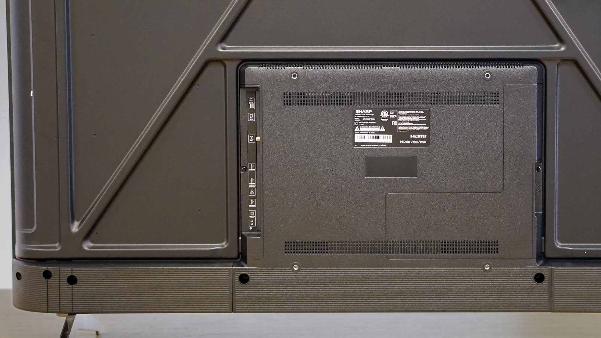 A closeup of the back of a Sharp Aquos QLED TV on a table