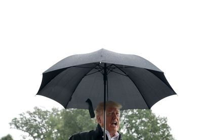 President Trump yells under an umbrella