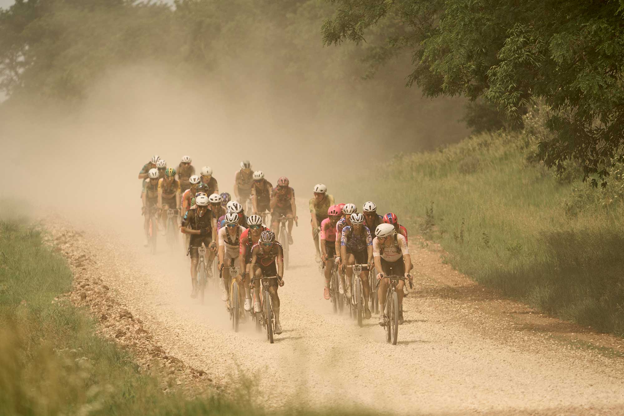 Petr Vakoč leads a group of riders on a gravel road