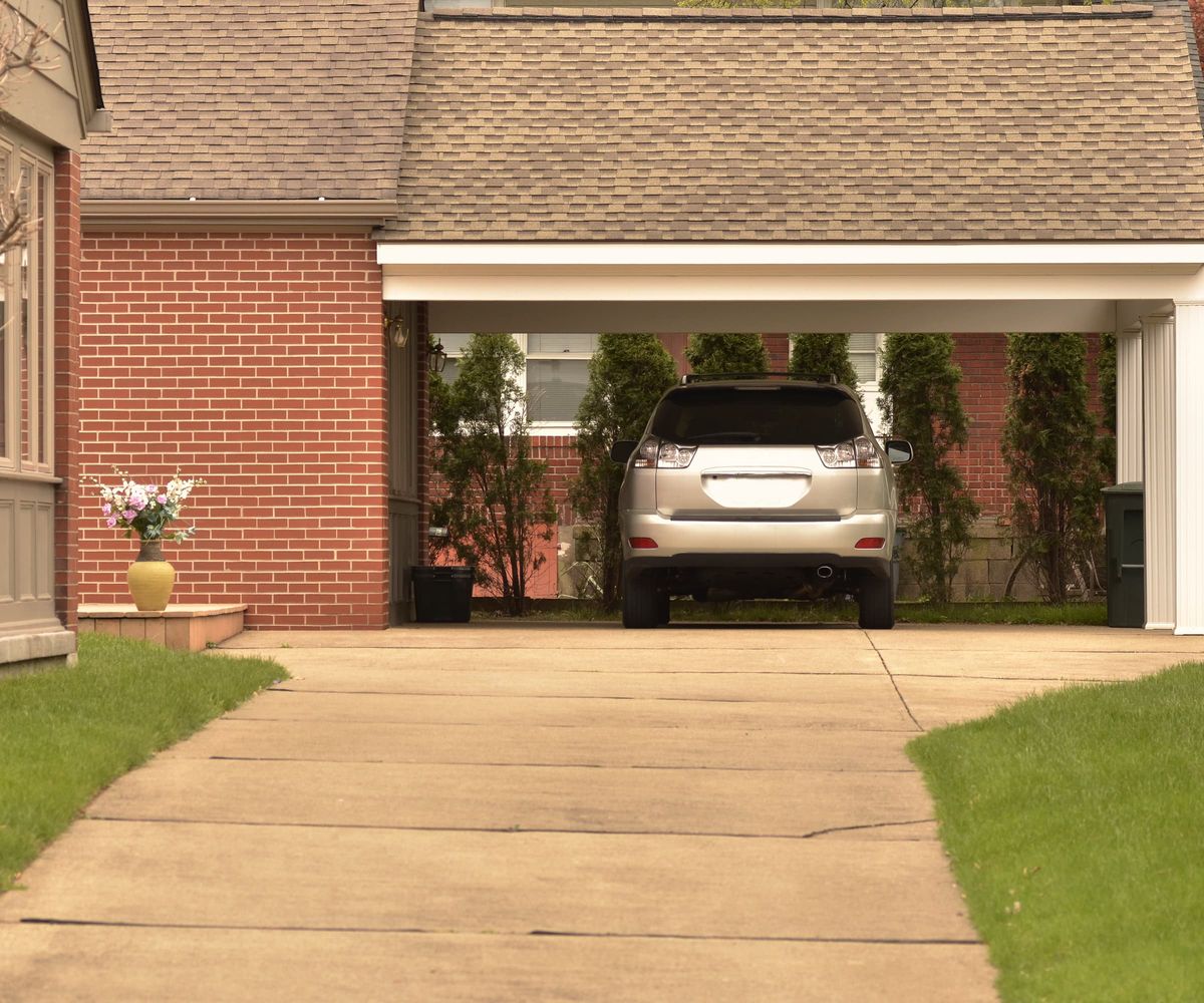 A silver car parked on a front driveway