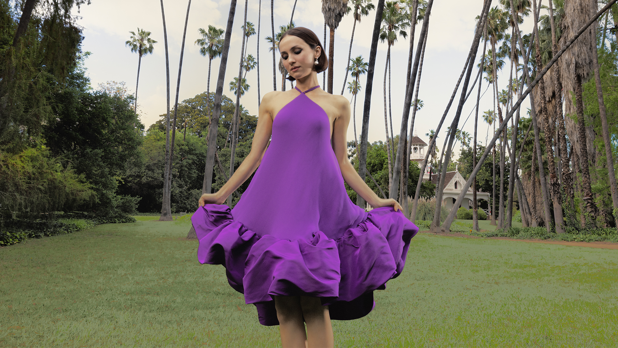 Maude Apatow for Who What Wear's May cover wearing a purple Balenciaga halter dress with ruffle detailing at the hem. 