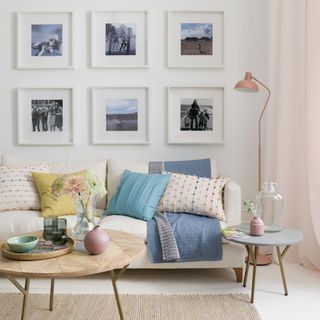 living room picture wall and white sofa with colourful cushions