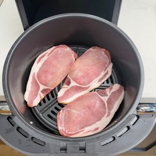 Raw bacon in the basket of the Ninja AF100UK Air Fryer