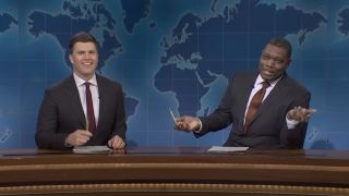 Colin Jost and Michael Che behind Weekend Update desk in SNL Season 50