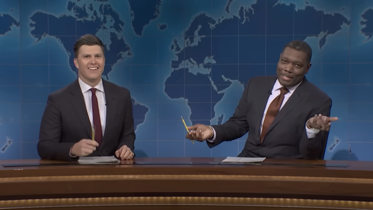 Colin Jost and Michael Che behind Weekend Update desk in SNL Season 50
