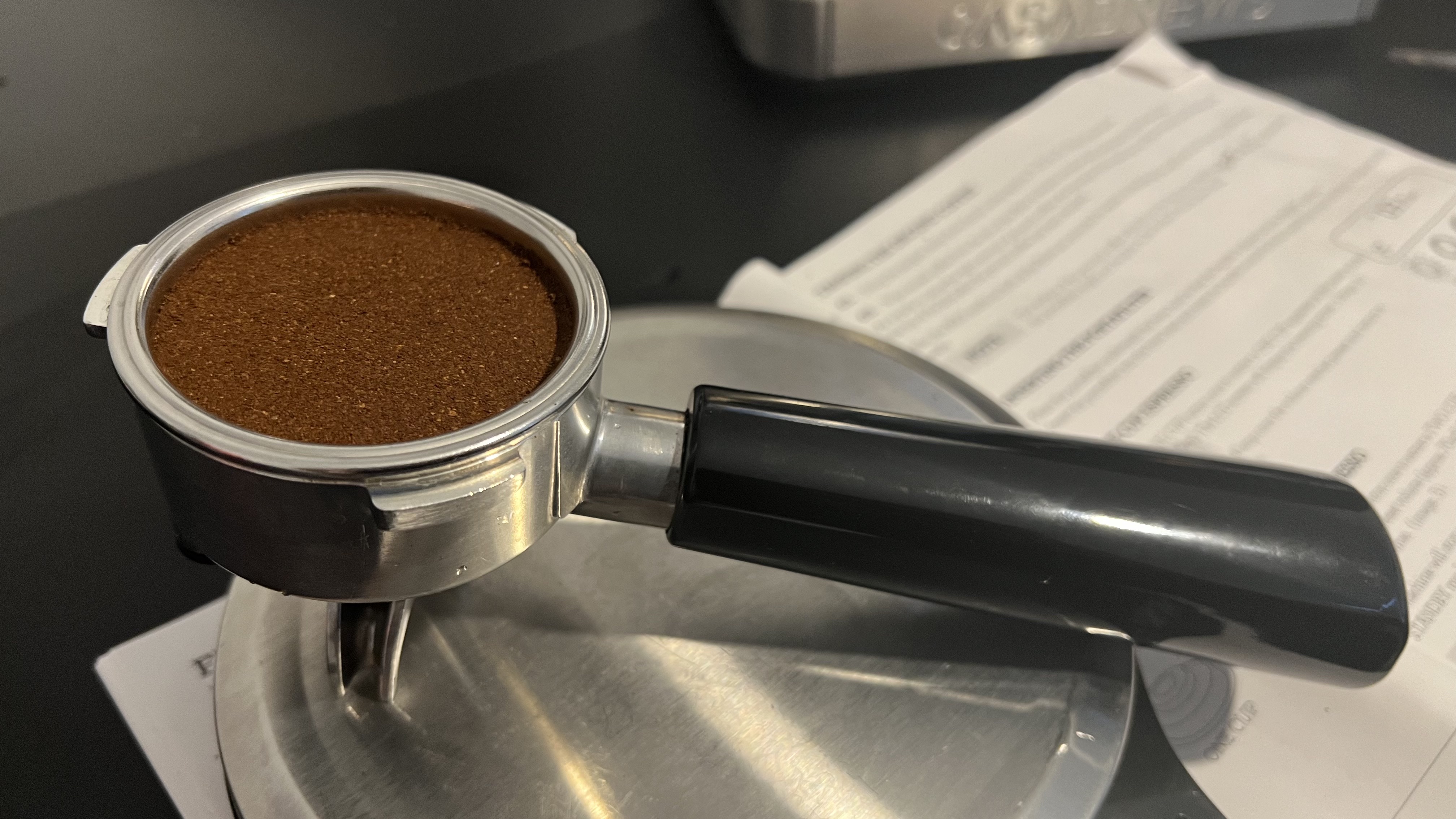 Casabrews Ultra Espresso Machine portafilter containing tamped coffee
