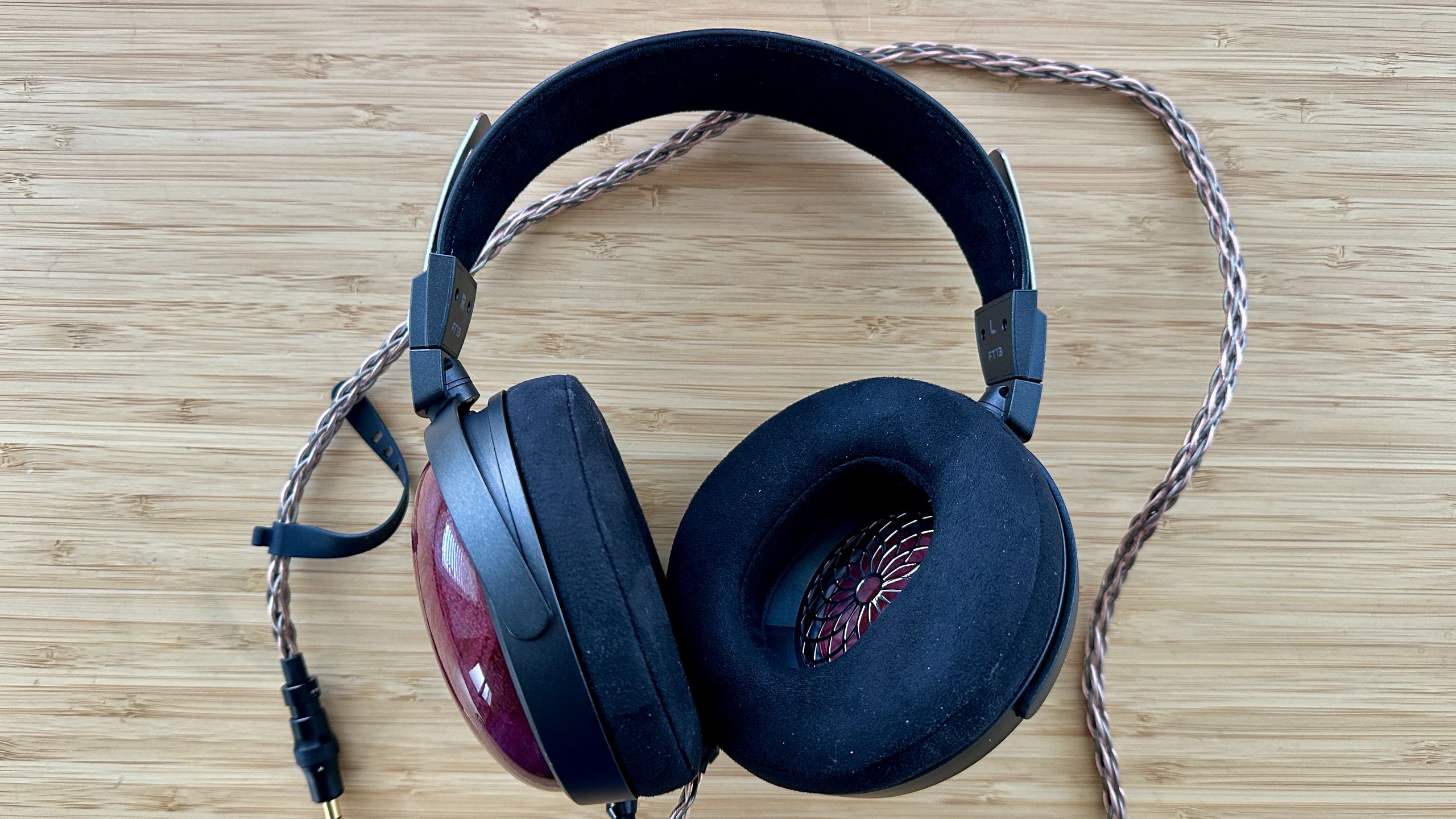 Ulasan headphone berkabel FiiO FT13: telinga tertutup dengan bagian belakang yang mengisi celah kecil dalam jajaran produk yang bertumpuk.