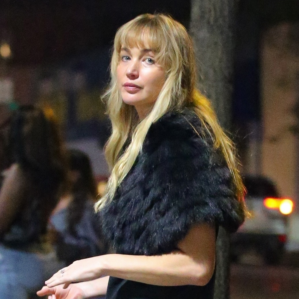 Jennifer Lawrence is spotted out and about in New York, wearing a black t-shirt and jeans and accessorizing it with black fur and a red leather bag.