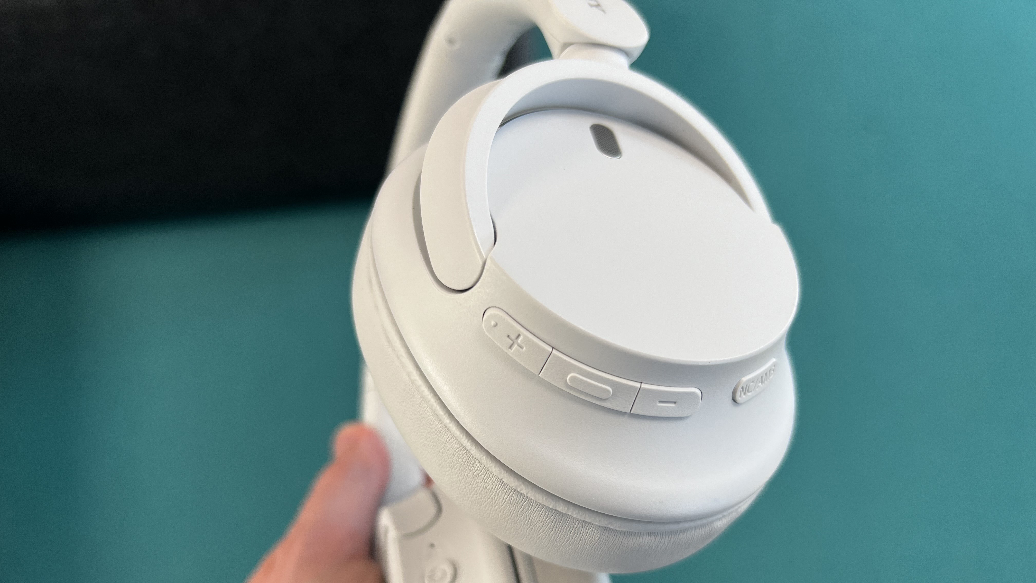 Sony WH-CH520N headphones play/pause buttons on the underside of an earcup