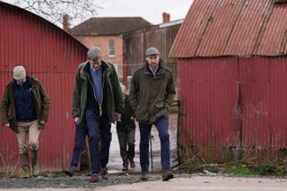 Prince William walking on a farm with several men in winter 2025