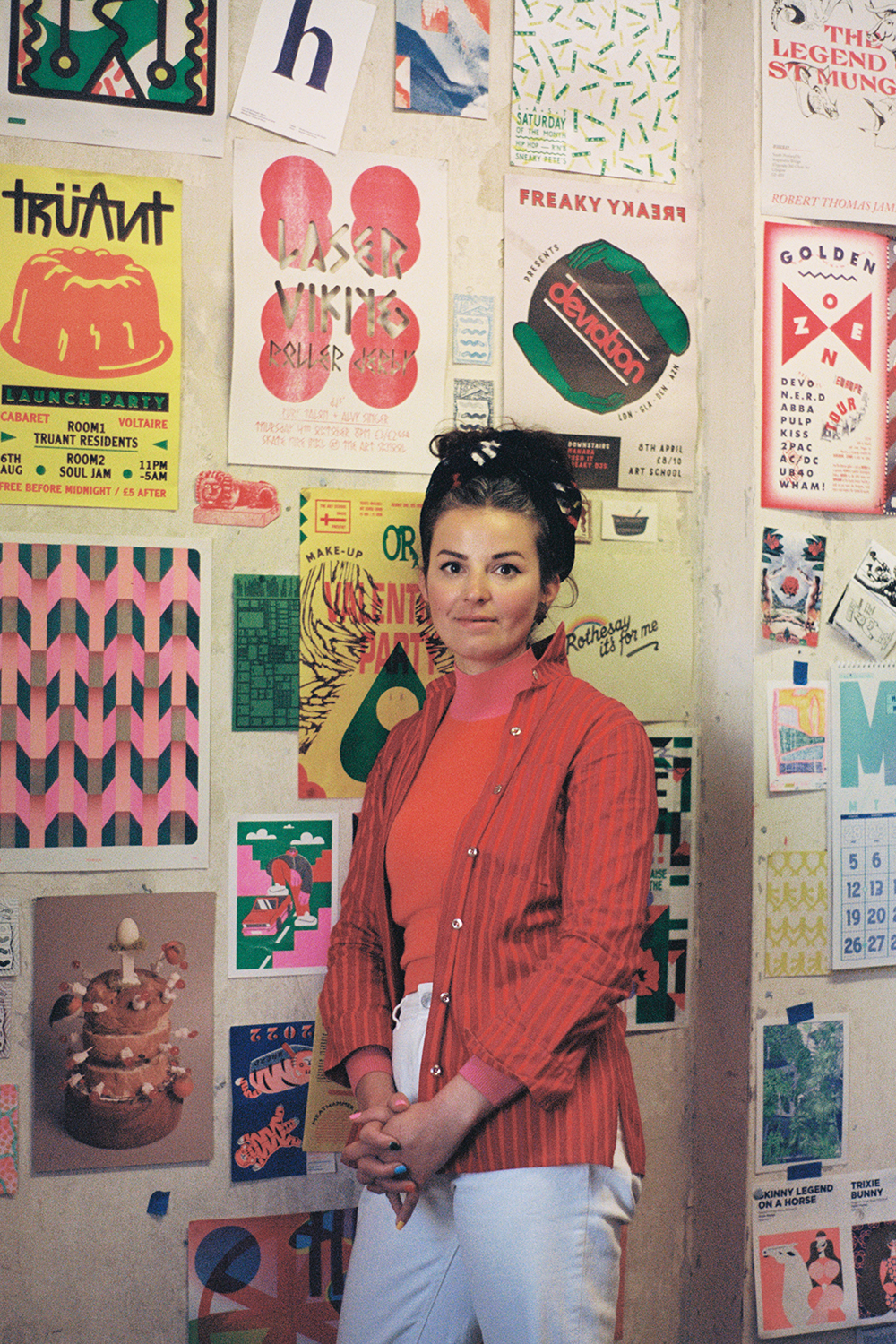 Portrait of Gabriella Marcella standing in front of gallery wall