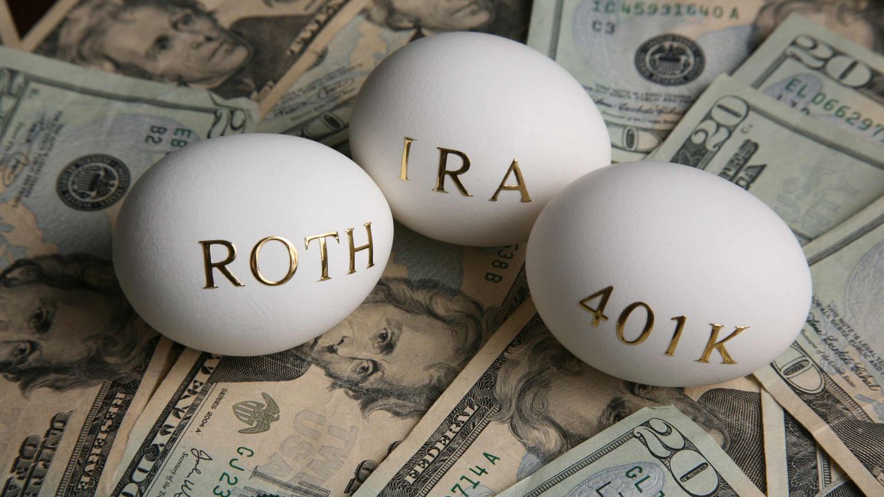 3 eggs with &amp;quot;Rpth,&amp;quot; &amp;quot;IRA,&amp;quot; and &amp;quot;401K&amp;quot; written on them sitting an a pile of U.S. dollars