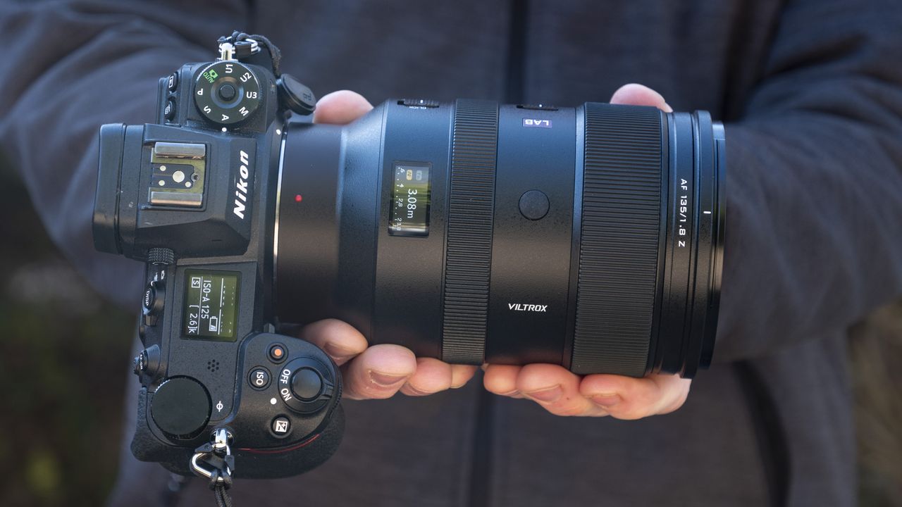 Viltrox 135mm F1.8 Lab lens for Nikon Z-mount, in the hand, attached to a Nikon Z6 II