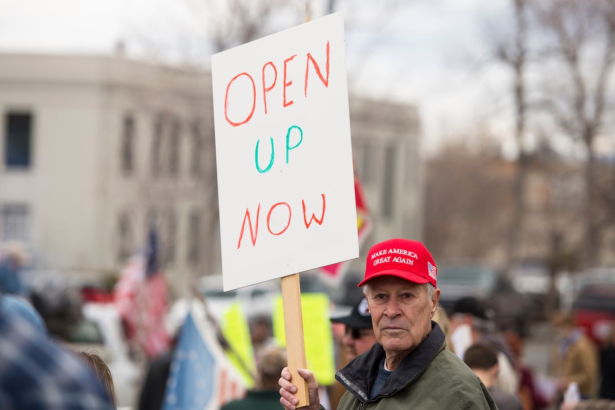 On April 19, a protestor in Helena, Montana holds up a sign to protest stay-at-home measures. Similar protests have taken hold across the country over the past couple of weeks.