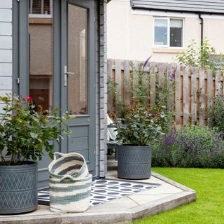 Garden extension with potted plants into lawn