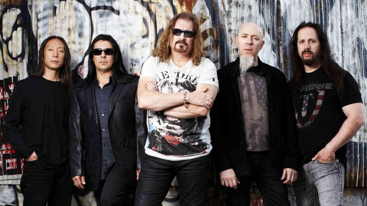 Dream Theater posing for a photograph in front of a graffitti’d wall