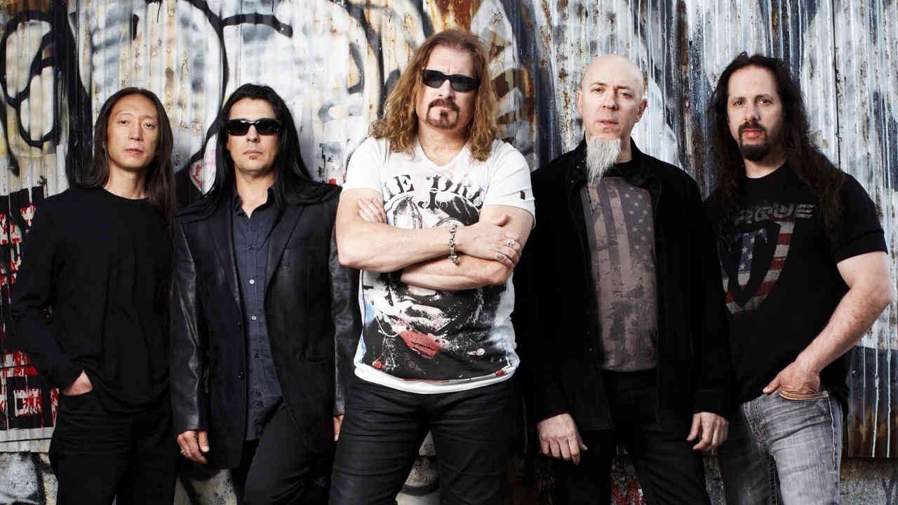 Dream Theater posing for a photograph in front of a graffitti’d wall