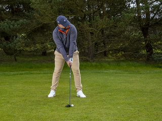 Peter Finch in the address position about to hit a golf shot on the golf course