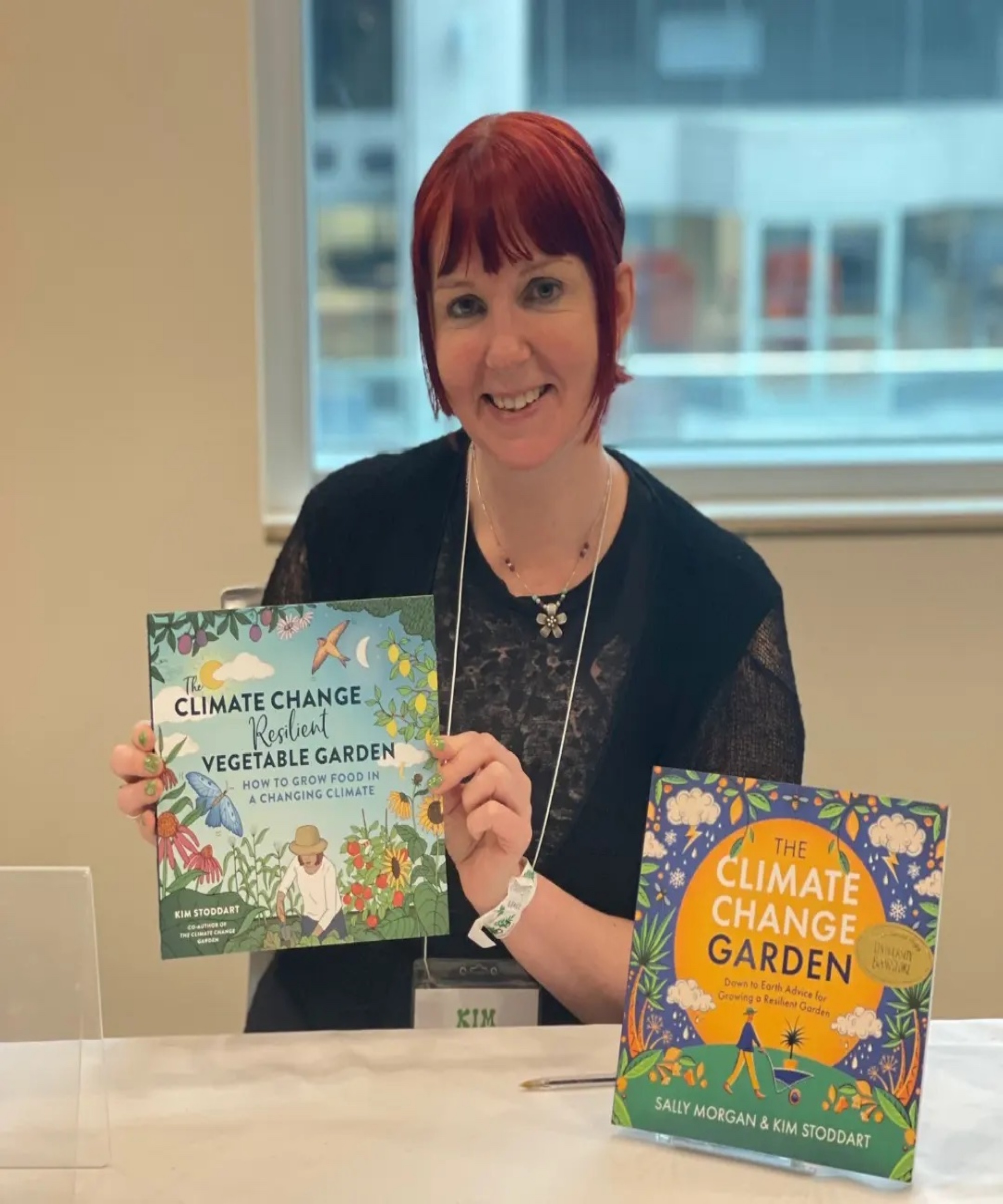 Author Kim Stoddart with her gardening books The Climate Change Resilient Vegetable Garden and The Climate Change Garden