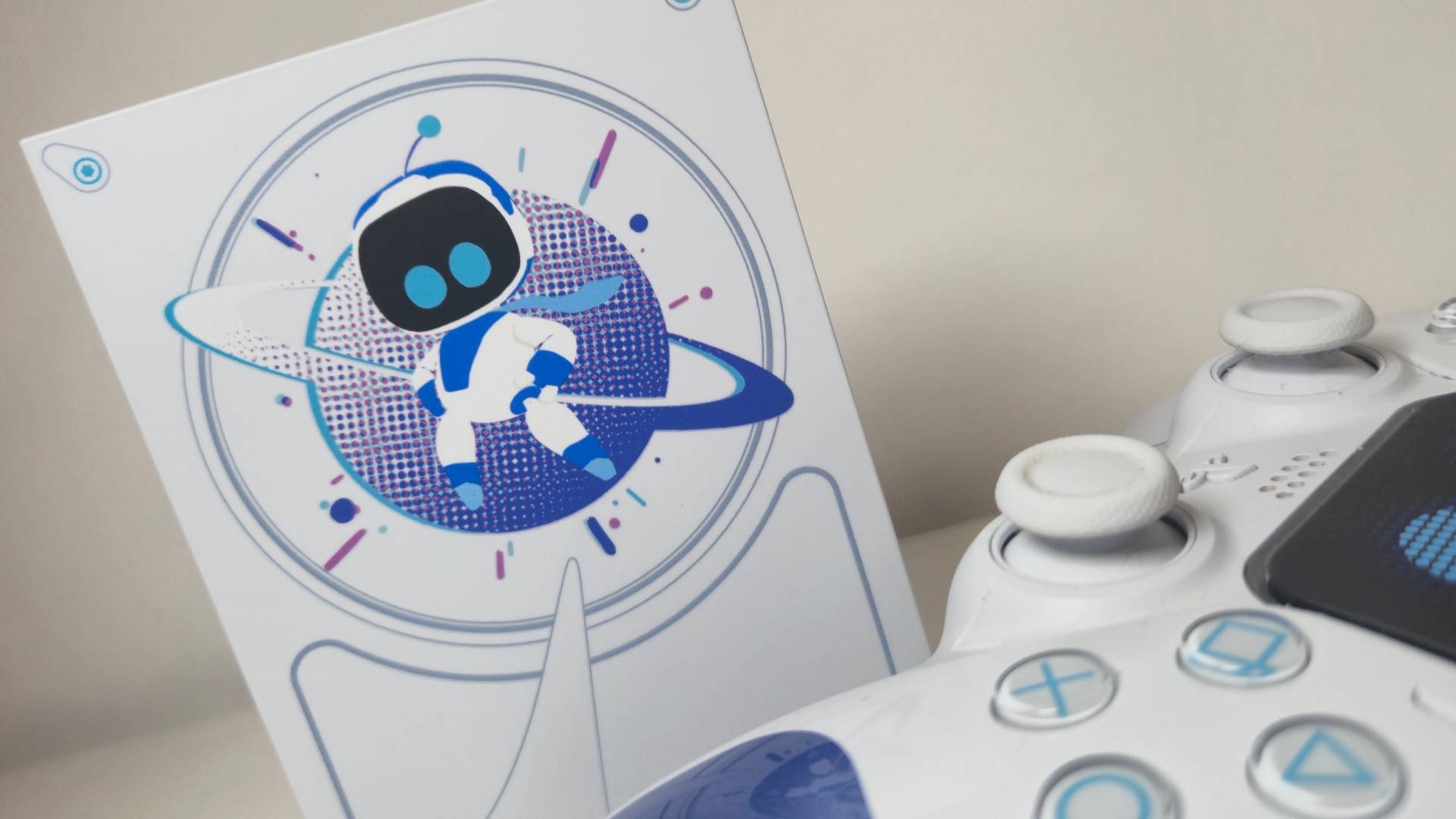 Photo of the Astro Bot imagery on the front of the Seagate game drive, with the Astro Bot DualSense to its side.