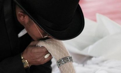 A Thai man kissed the hand of his deceased bride at a funeral-cum-wedding he hosted after her untimely death.