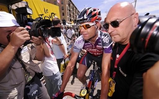 Cadel Evans is escorted away by 'big Serge' after the finish in La Grande Motte.