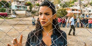 Luciana looking through a fence in Fear The Walking Dead