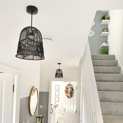 hallway with grey stairs and black pendant light