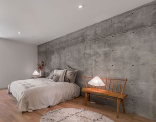 Tactile concrete wall in the bedroom.