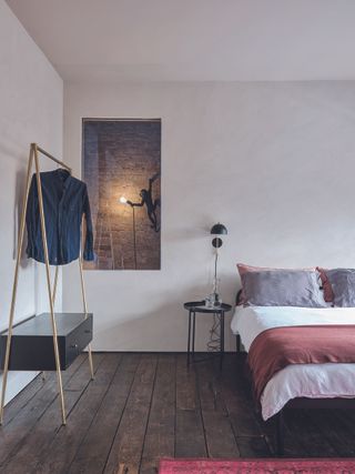 A bedroom with pale pink walls