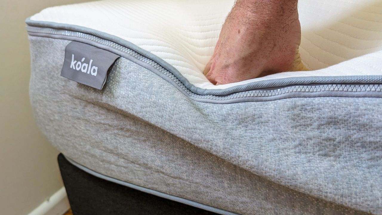 Koala mattress edge support shown by hand