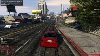 GTA 5 mods - a red car is driving down a road with tall buildings in the distance