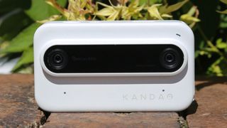 The Kandao Qoocam Ego 3D camera sat on a brick wall