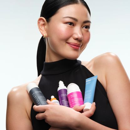 Woman holding Paula's Choice bestselling products