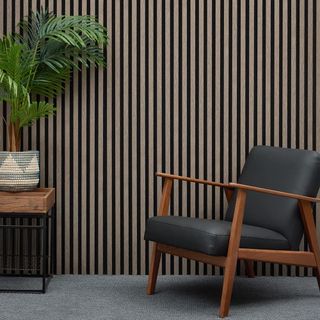 WBM Acoustic Slat Wall Panel with an accent chair and a large plant