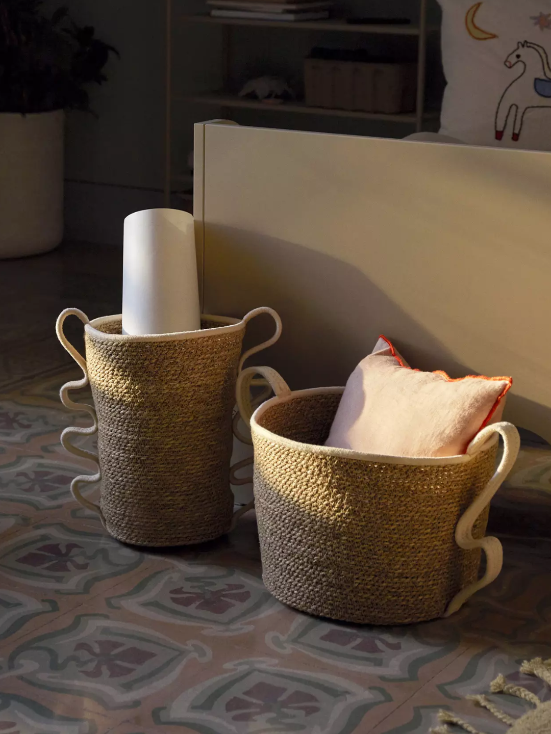 A set of two woven storage baskets with curved handles from Ferm Living
